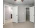 Bedroom featuring neutral walls and carpet and doors to the closet and hallway at 11302 Musette Cir, Alpharetta, GA 30009