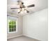 Bedroom featuring wainscoting, a ceiling fan, a window, and carpet at 11302 Musette Cir, Alpharetta, GA 30009