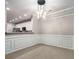 Dining area with view of kitchen, detailed trim, and unique lighting fixture at 11302 Musette Cir, Alpharetta, GA 30009