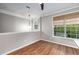 The bright dining room offers hardwood floors, neutral walls, modern lighting and an open floor plan at 11302 Musette Cir, Alpharetta, GA 30009