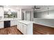 The bright dining room offers hardwood floors, neutral walls, modern lighting and an open floor plan at 11302 Musette Cir, Alpharetta, GA 30009