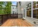 Exterior wooden deck featuring the exterior of the home, door, and windows at 11302 Musette Cir, Alpharetta, GA 30009