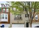 Inviting townhome featuring a garage and classic brick exterior with a well-manicured lawn at 11302 Musette Cir, Alpharetta, GA 30009