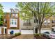 Charming townhome featuring brick and gray painted facade, complemented by an attached two-car garage and tasteful landscaping at 11302 Musette Cir, Alpharetta, GA 30009