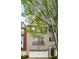Charming townhome featuring a gray painted facade, complemented by an attached two-car garage and tasteful landscaping at 11302 Musette Cir, Alpharetta, GA 30009