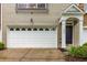 Charming townhome with a well-maintained garage, entryway, and landscaped front yard at 11302 Musette Cir, Alpharetta, GA 30009