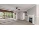 Spacious living room with fireplace, balcony access, and neutral color scheme at 11302 Musette Cir, Alpharetta, GA 30009