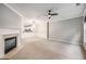 Open concept living room featuring a fireplace and an open view to the kitchen at 11302 Musette Cir, Alpharetta, GA 30009