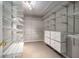 Large walk-in closet with custom shelving and drawers offers ample storage space at 11302 Musette Cir, Alpharetta, GA 30009
