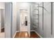 A walk-in closet with custom shelving leads to an ensuite bathroom with a wood floor at 11302 Musette Cir, Alpharetta, GA 30009