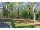Scenic view of a large backyard with lush green grass and mature trees at 1441 Cahaba Sw Dr, Atlanta, GA 30311