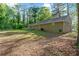 Large backyard with green grass and mature trees surrounding the property at 1441 Cahaba Sw Dr, Atlanta, GA 30311