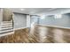 Spacious basement featuring gray walls, wooden floors, and stairs to the upper level at 1441 Cahaba Sw Dr, Atlanta, GA 30311