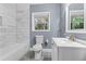 Bathroom featuring a tub, toilet, sink, and window for natural light at 1441 Cahaba Sw Dr, Atlanta, GA 30311