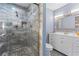 Bathroom features a tiled shower with a glass door and vanity with white cabinets at 1441 Cahaba Sw Dr, Atlanta, GA 30311