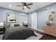 Bedroom with neutral paint, wood floor, bed, nightstands, rug and white barn door to closet at 1441 Cahaba Sw Dr, Atlanta, GA 30311