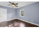 Light filled bedroom with a ceiling fan, hardwood floors, and window for natural light at 1441 Cahaba Sw Dr, Atlanta, GA 30311