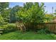 A wooden staircase leads into a backyard of a fenced-in home at 2500 Kingsbrooke Ln, Duluth, GA 30097