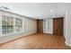 Finished basement with wood laminate floors, large windows, and custom storage cabinets at 2500 Kingsbrooke Ln, Duluth, GA 30097