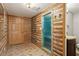 Unique bath with faux log walls, a glass shower, and a wood vanity at 2500 Kingsbrooke Ln, Duluth, GA 30097