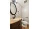 Charming bathroom features a stylish vanity with bronze fixtures and a round mirror at 2500 Kingsbrooke Ln, Duluth, GA 30097