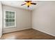 Bedroom with a ceiling fan, hardwood floors and a large window with natural light at 2500 Kingsbrooke Ln, Duluth, GA 30097