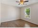 Cozy bedroom with hardwood floors, ceiling fan, and a large window with view at 2500 Kingsbrooke Ln, Duluth, GA 30097