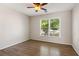 Bedroom with hardwood floors, ceiling fan, and large window for natural light at 2500 Kingsbrooke Ln, Duluth, GA 30097