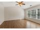 Spacious bedroom featuring hardwood floors, neutral paint and a ceiling fan at 2500 Kingsbrooke Ln, Duluth, GA 30097