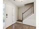 Bright foyer showcasing hardwood floors, a staircase, and a decorative front door at 2500 Kingsbrooke Ln, Duluth, GA 30097