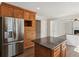 Stylish kitchen with a stainless steel refrigerator, granite counters, and a center island at 2500 Kingsbrooke Ln, Duluth, GA 30097