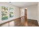 Bright living room featuring hardwood floors, a large window, and an open doorway at 2500 Kingsbrooke Ln, Duluth, GA 30097