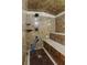 Luxurious shower with marble tile, custom seating, and overhead shower system at 2500 Kingsbrooke Ln, Duluth, GA 30097