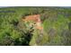Bird's-eye view of the property, showcasing the house, barn, and surrounding trees at 537 Craven Rd, Roopville, GA 30170
