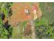 High angle shot of the land showing a barn, trailers, and a house surrounded by lush trees at 537 Craven Rd, Roopville, GA 30170