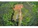Aerial view of the estate featuring a large house, barn, and trailers surrounded by lush greenery at 537 Craven Rd, Roopville, GA 30170