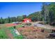 Aerial view of a horse farm featuring a barn, paddocks, and open fields at 537 Craven Rd, Roopville, GA 30170