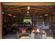 Barn interior with overhead lighting storing tractors, trucks and recreational vehicles at 537 Craven Rd, Roopville, GA 30170