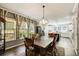 Dining area with a chandelier, connecting to a modern kitchen with an island and updated appliances at 537 Craven Rd, Roopville, GA 30170