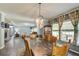 Dining room connecting to a spacious living area, with natural light and view of a stone fireplace at 537 Craven Rd, Roopville, GA 30170