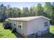 Charming single-story home with well-maintained lawn and mature trees at 537 Craven Rd, Roopville, GA 30170