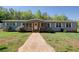 Charming single-story home with a covered front porch, inviting curb appeal and walkway leading to the front door at 537 Craven Rd, Roopville, GA 30170