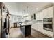 Modern kitchen with white cabinetry, stainless steel appliances, an island, and stylish backsplash at 537 Craven Rd, Roopville, GA 30170