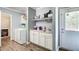 Laundry room with washer, dryer, sink, and storage cabinets, designed for convenience and efficiency at 537 Craven Rd, Roopville, GA 30170