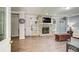 Spacious living room with a stone fireplace, built-in shelving, and warm wood-look flooring, offering a cozy atmosphere at 537 Craven Rd, Roopville, GA 30170