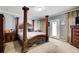 Spacious main bedroom with a four poster bed, neutral tones, and a private door to the exterior at 537 Craven Rd, Roopville, GA 30170