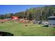 Expansive property with a red barn, a paddock, and a vehicle parking area at 537 Craven Rd, Roopville, GA 30170