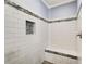 Tiled shower with a built-in bench and decorative accents, providing a luxurious bathing experience at 537 Craven Rd, Roopville, GA 30170