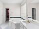 Elegant bathroom boasting a soaking tub, a separate vanity, and a large mirror, creating a serene and functional space at 5494 White Cedar Ter, Sugar Hill, GA 30518