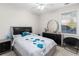 A bedroom featuring a bed with floral pattern bedding, and dark colored furniture at 5494 White Cedar Ter, Sugar Hill, GA 30518